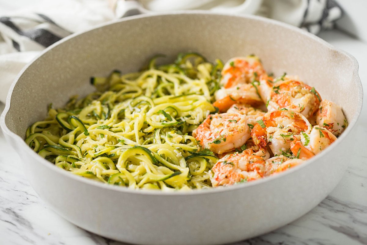Shrimps and zucchini noodles cooked in fresh garlic and lemon juice and topped with finely chopped fresh herbs
