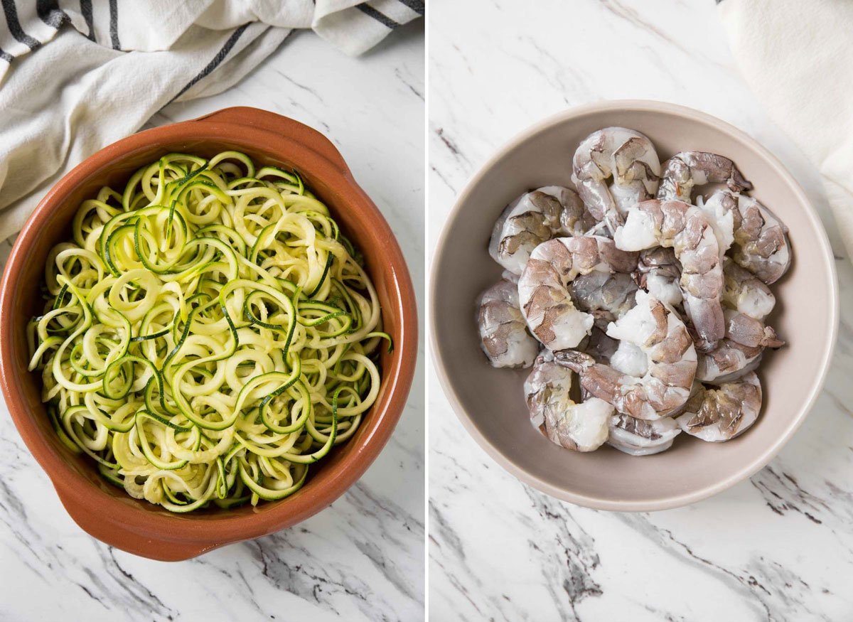 Zucchini noodles and raw shrimp in a bowl for making garlic shrimp and zucchini pasta.