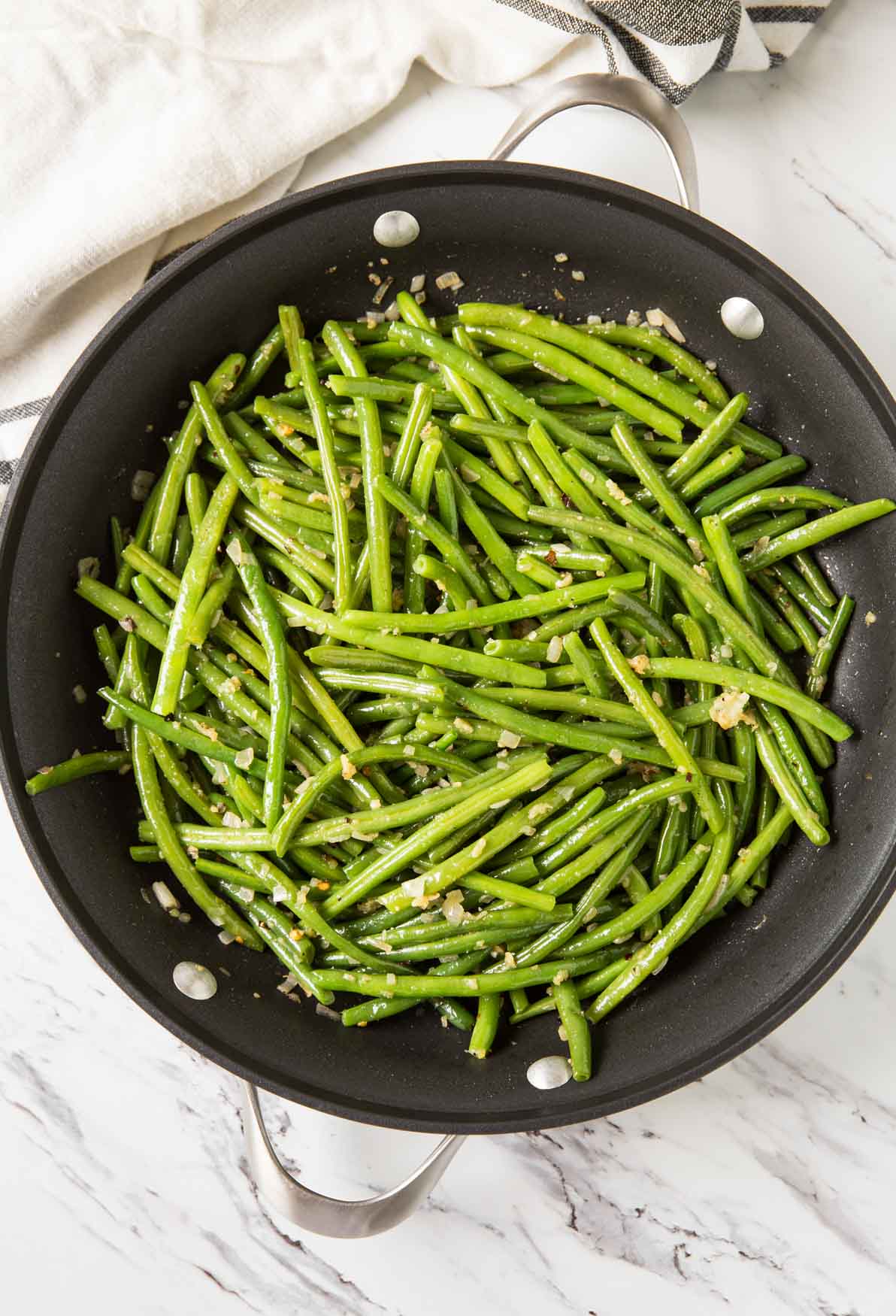 Sautéed garlic green beans in a skillet.