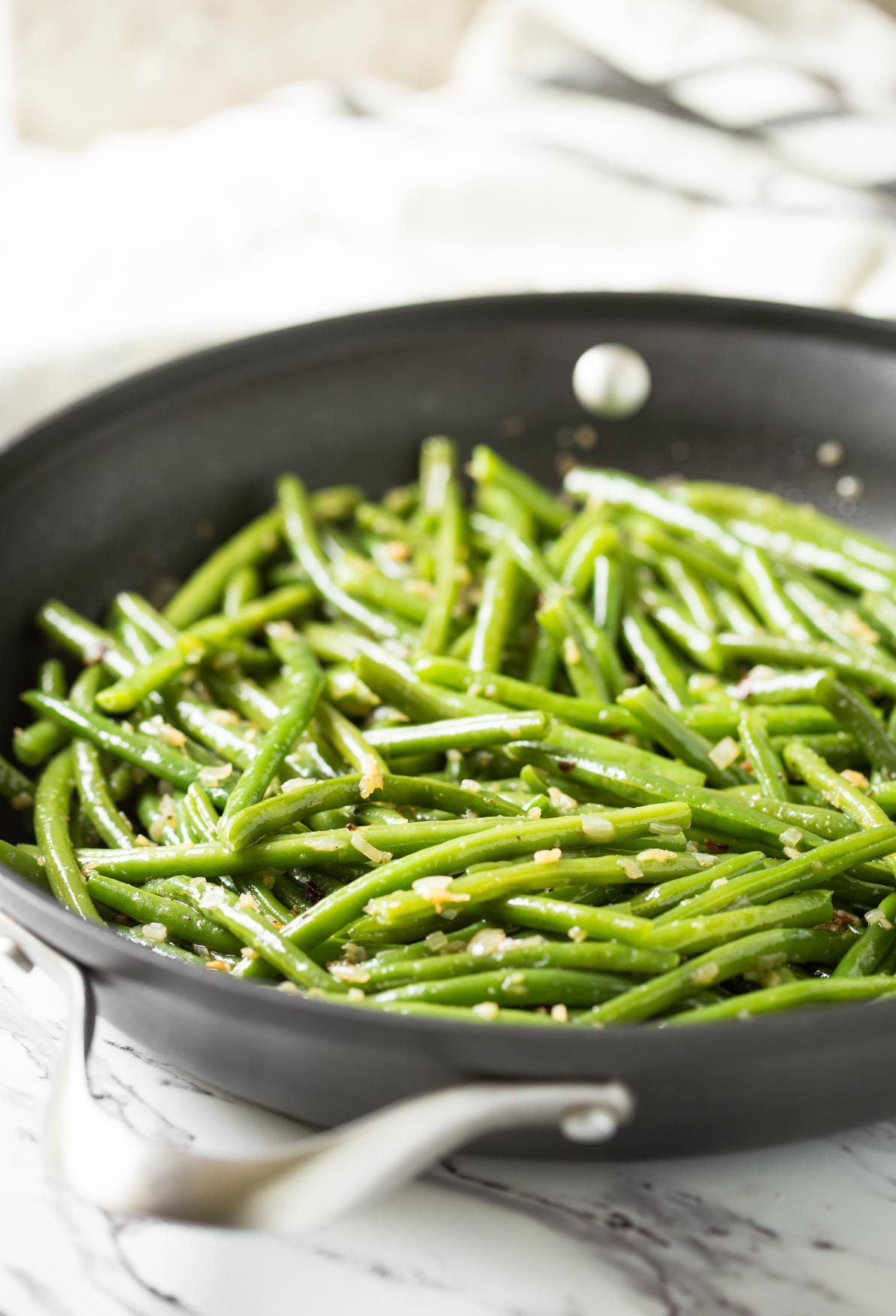 Sautéed garlic green beans in a skillet.