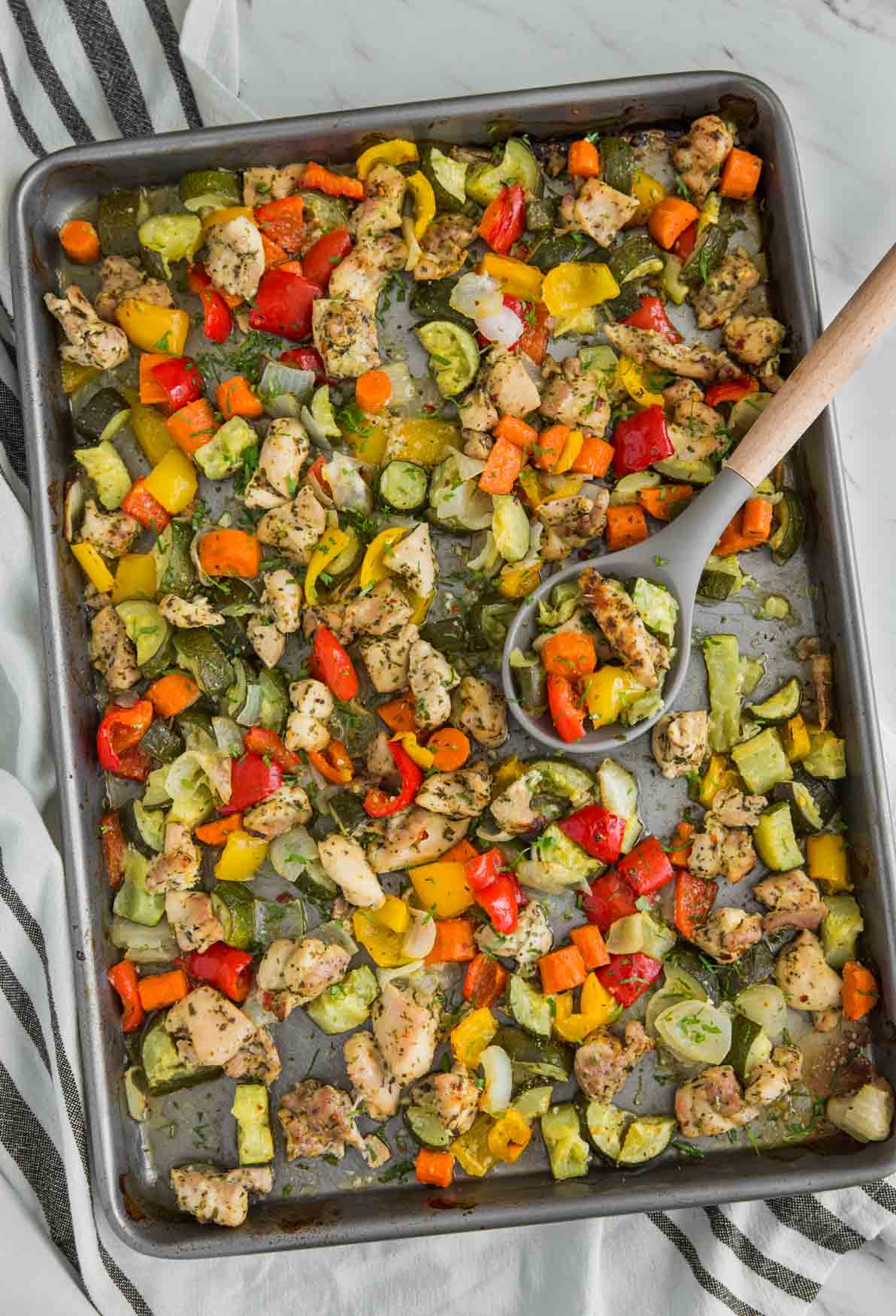 One-pan baked chicken and vegetables in a baking tray ready to serve