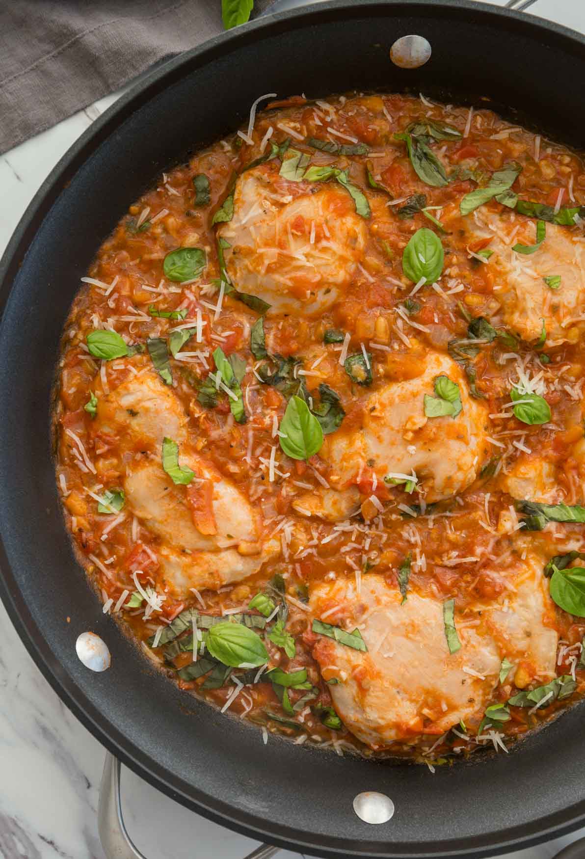Garlic basil chicken in tomato sauce in a large skillet.