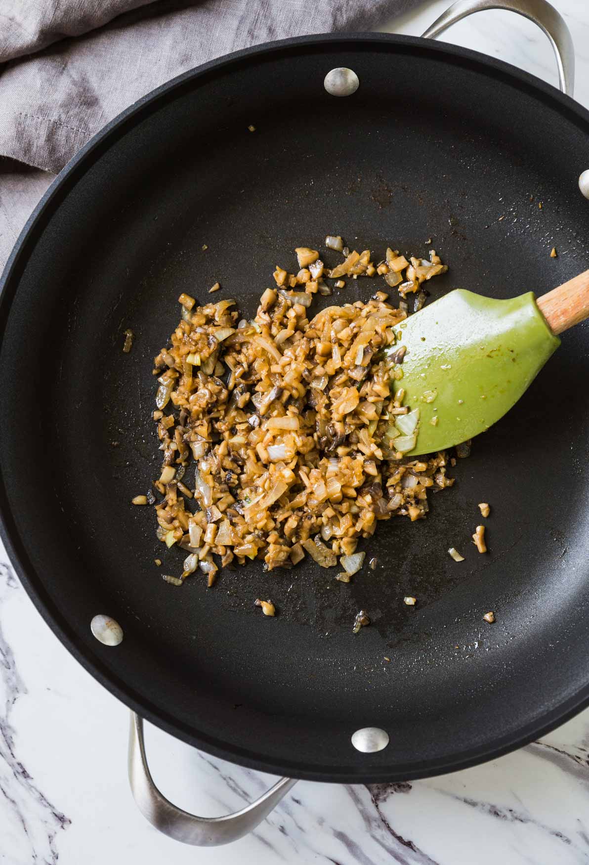 sautéing mushroom and onion in large skillet for making mushroom gravy 