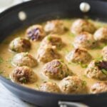 Healthy ground turkey meatballs with gravy in a large skillet
