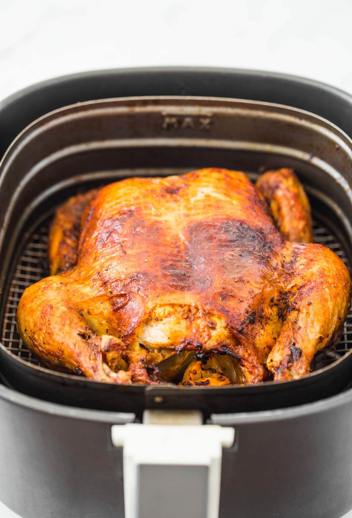 Roasted whole chicken in Air Fryer basket