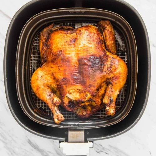 Roasted whole chicken in Air Fryer basket