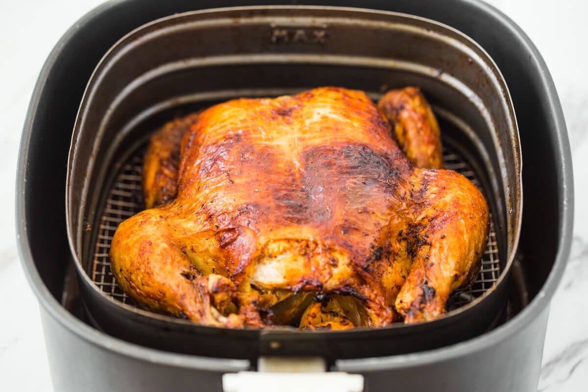 Roasted whole chicken in Air Fryer basket