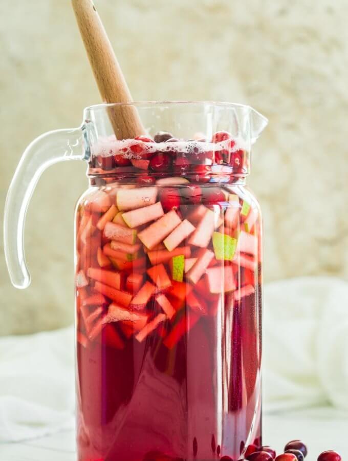 Cranberry Sangria in a large pitcher is ready to serve