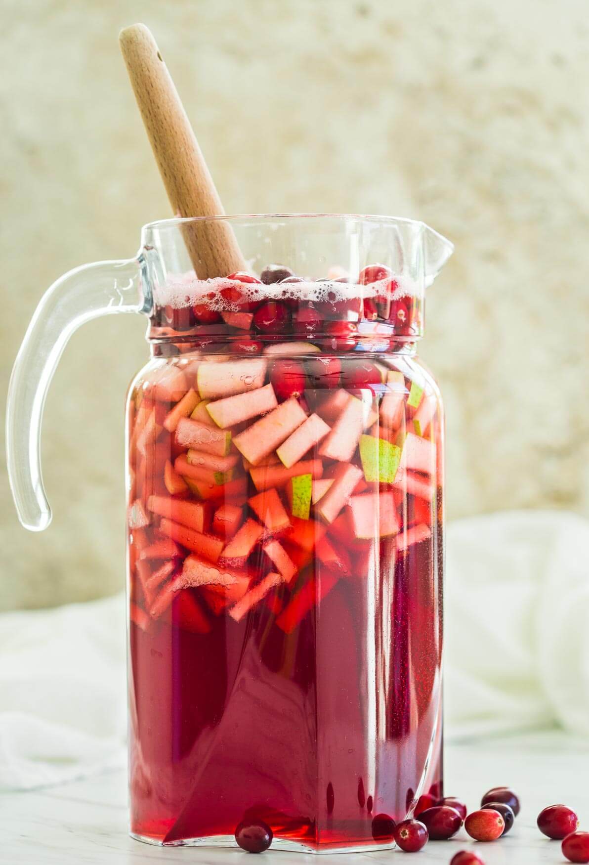 Cranberry Sangria in a large pitcher is ready to serve.