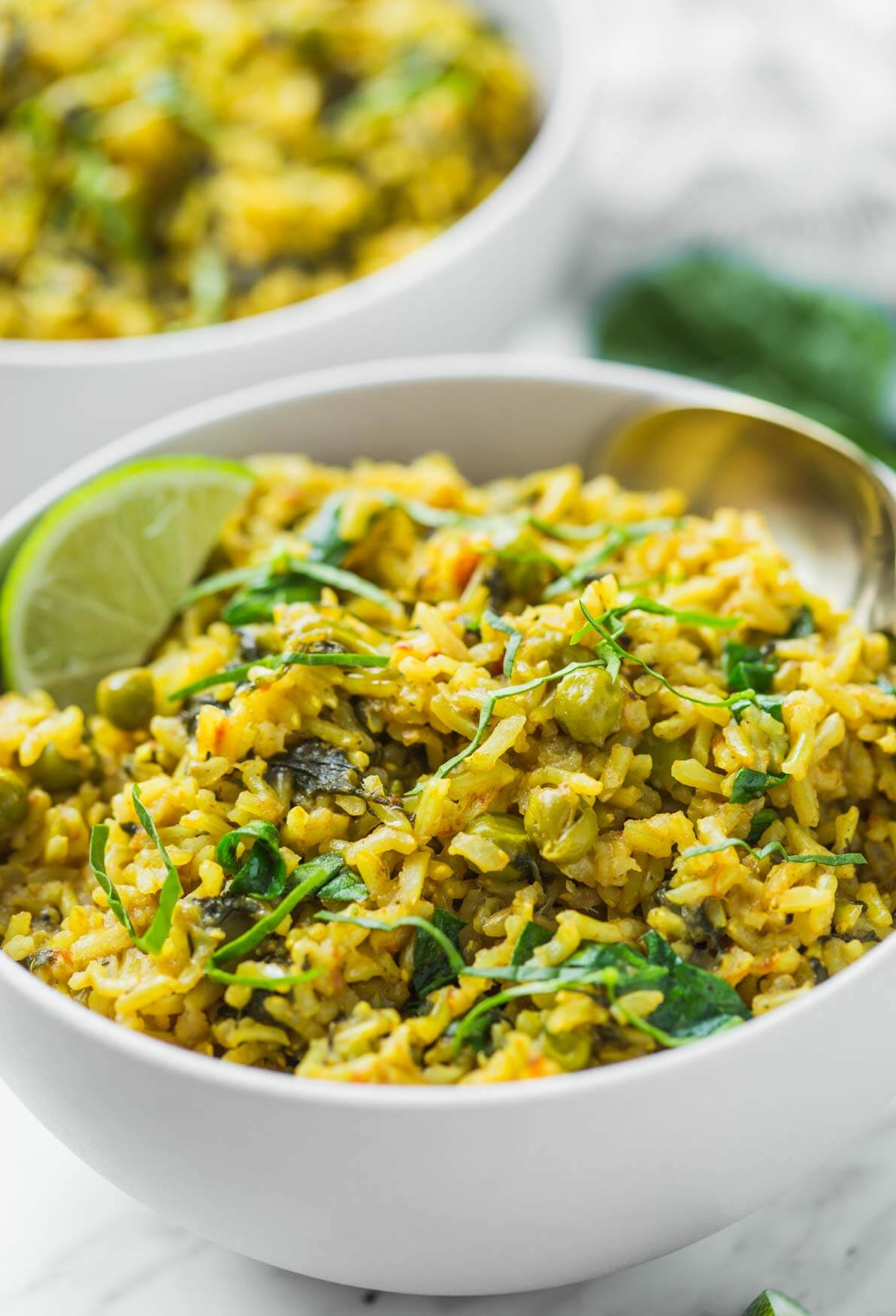 Instant Pot spinach with brown rice and green peas in a serving bowl