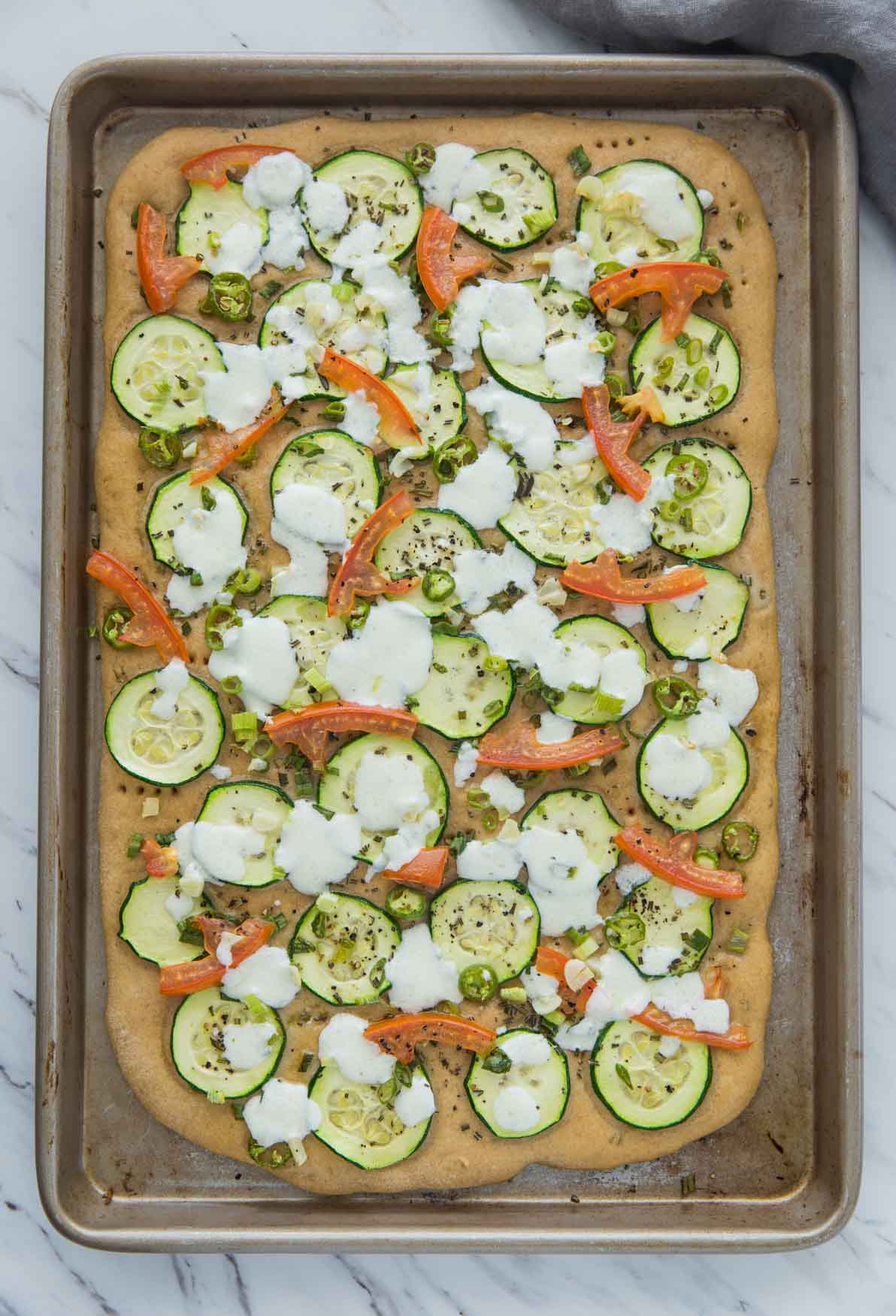 image of baked zucchini flatbread in the baking tray.