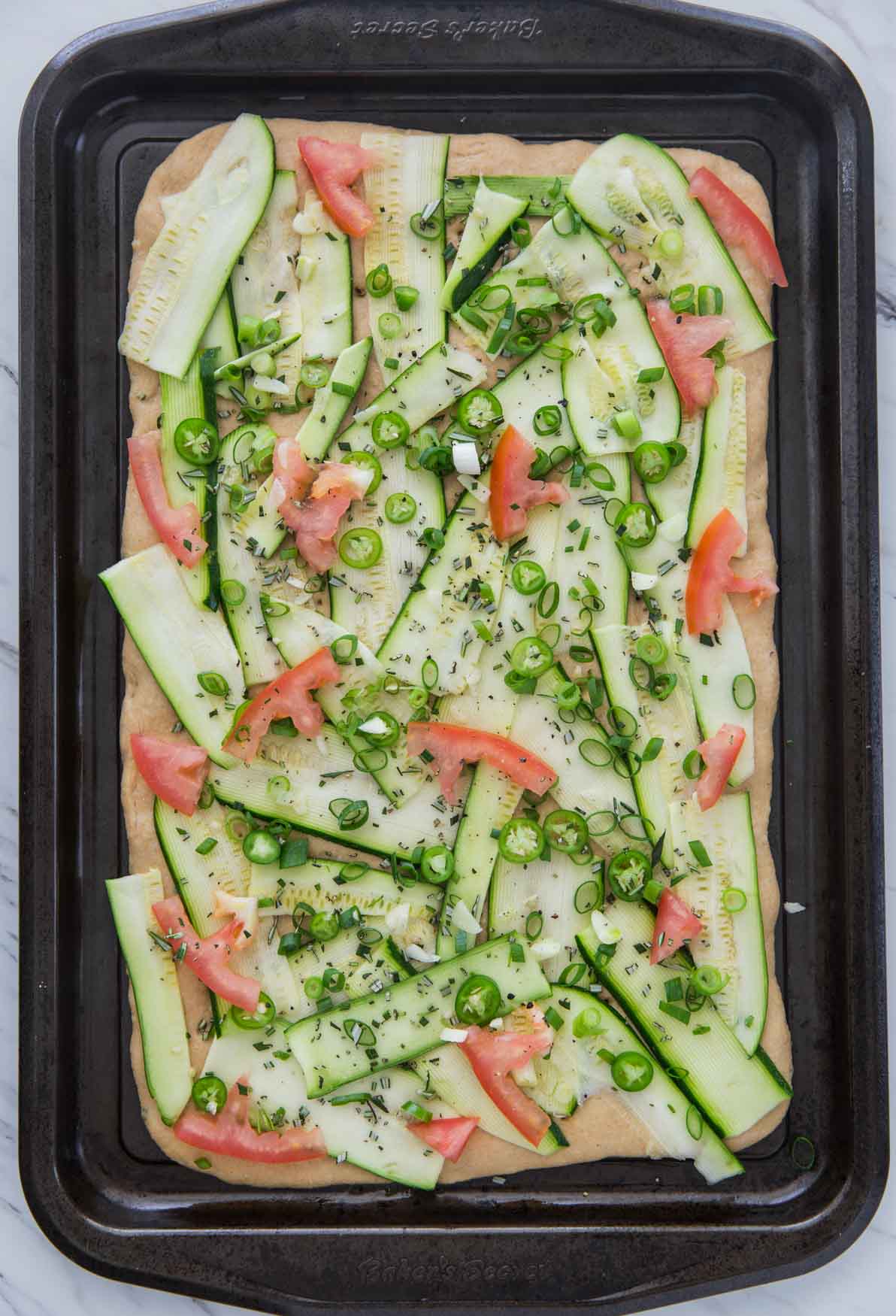 image of flatbread with all the toppings ready to bake.