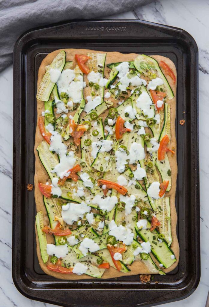 image of baked zucchini flatbread in the baking tray.