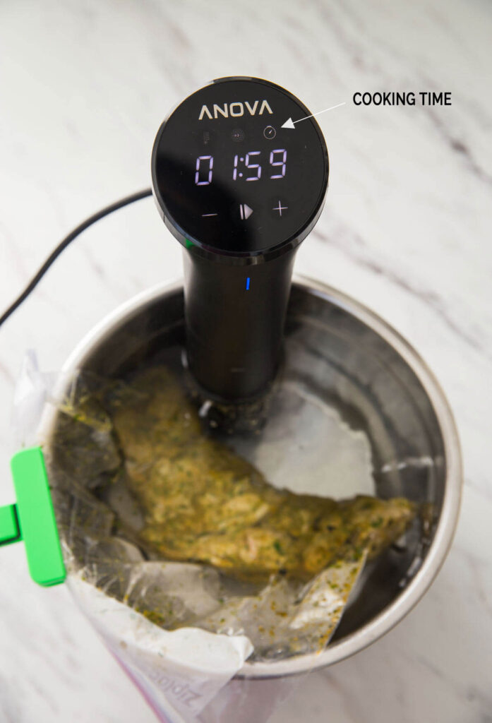 Image during Sous Vide Chicken Thighs with Anova Cooker showing cooking time on its display.