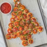 pull apart pizza bites arranged in Christmas tree shape on baking sheet.