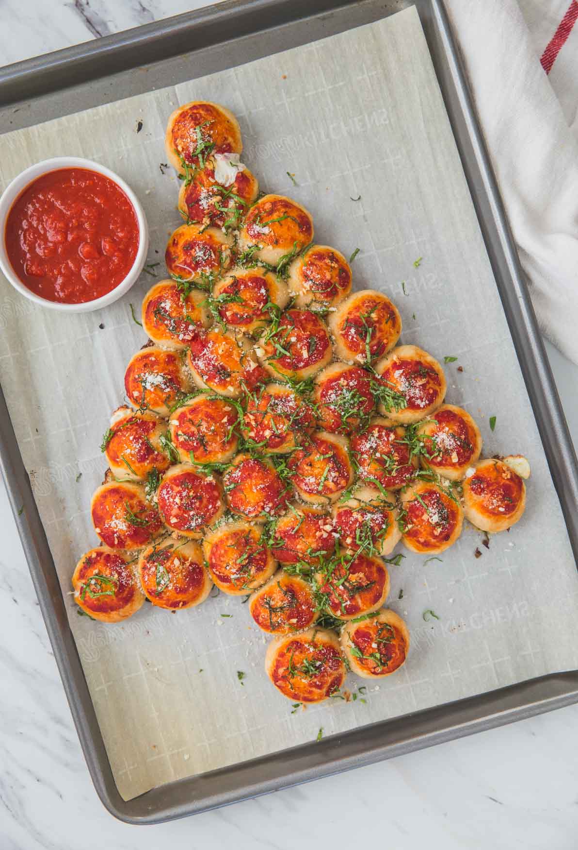 pull apart pizza bites arranged in Christmas tree shape on baking sheet.