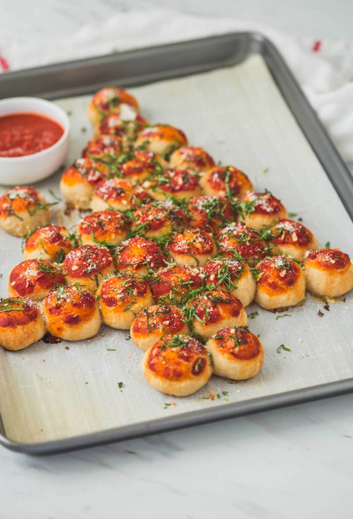 pull apart pizza bites arranged in Christmas tree shape on baking sheet.