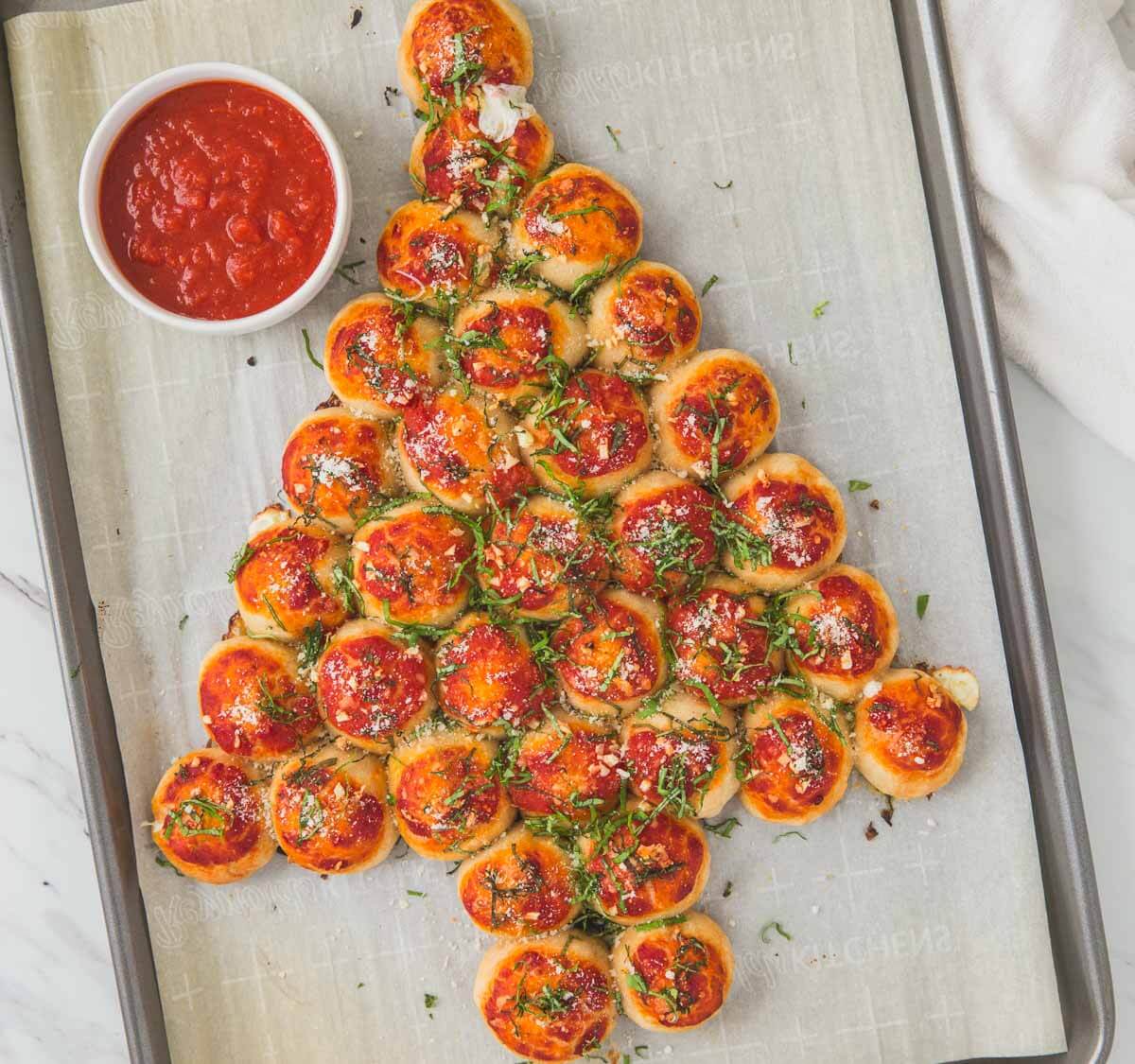 pull apart pizza bites arranged in Christmas tree shape on baking sheet.