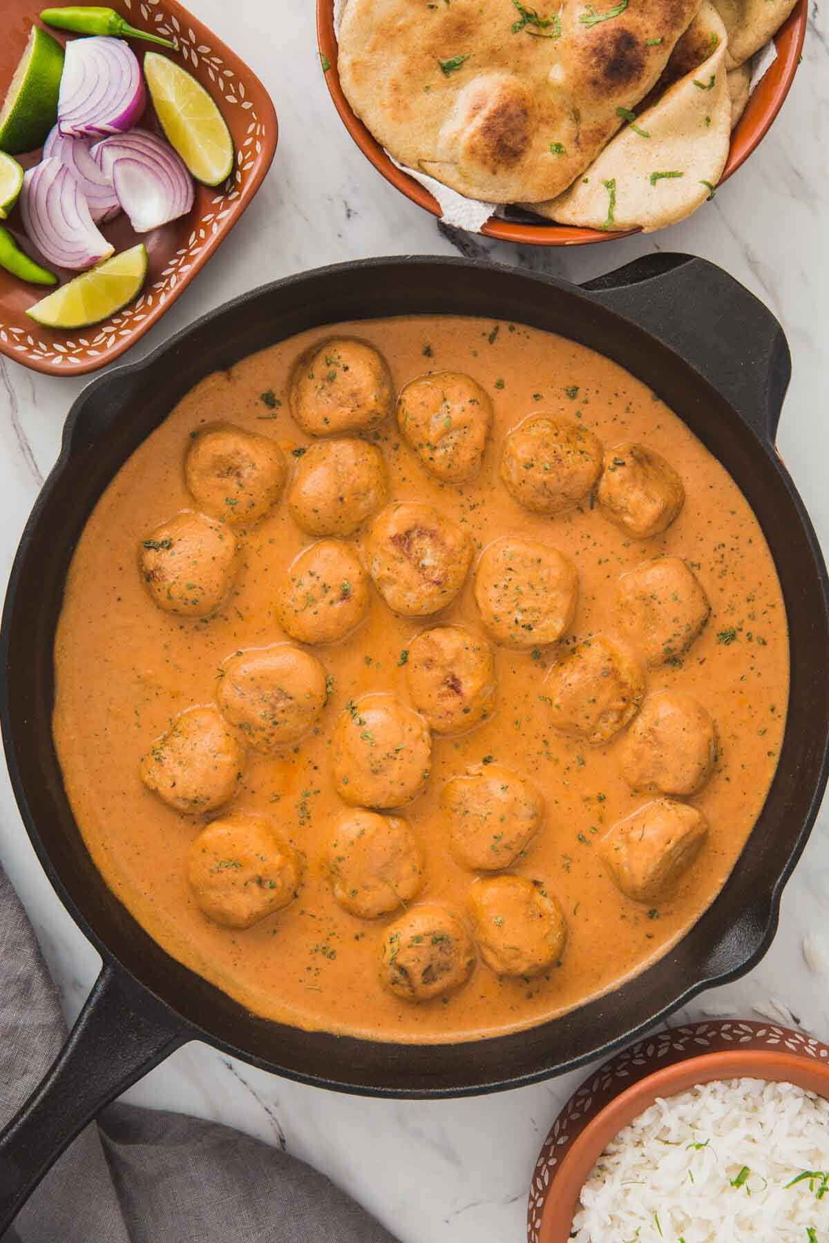 Butter chicken meatballs in a cast iron skillet