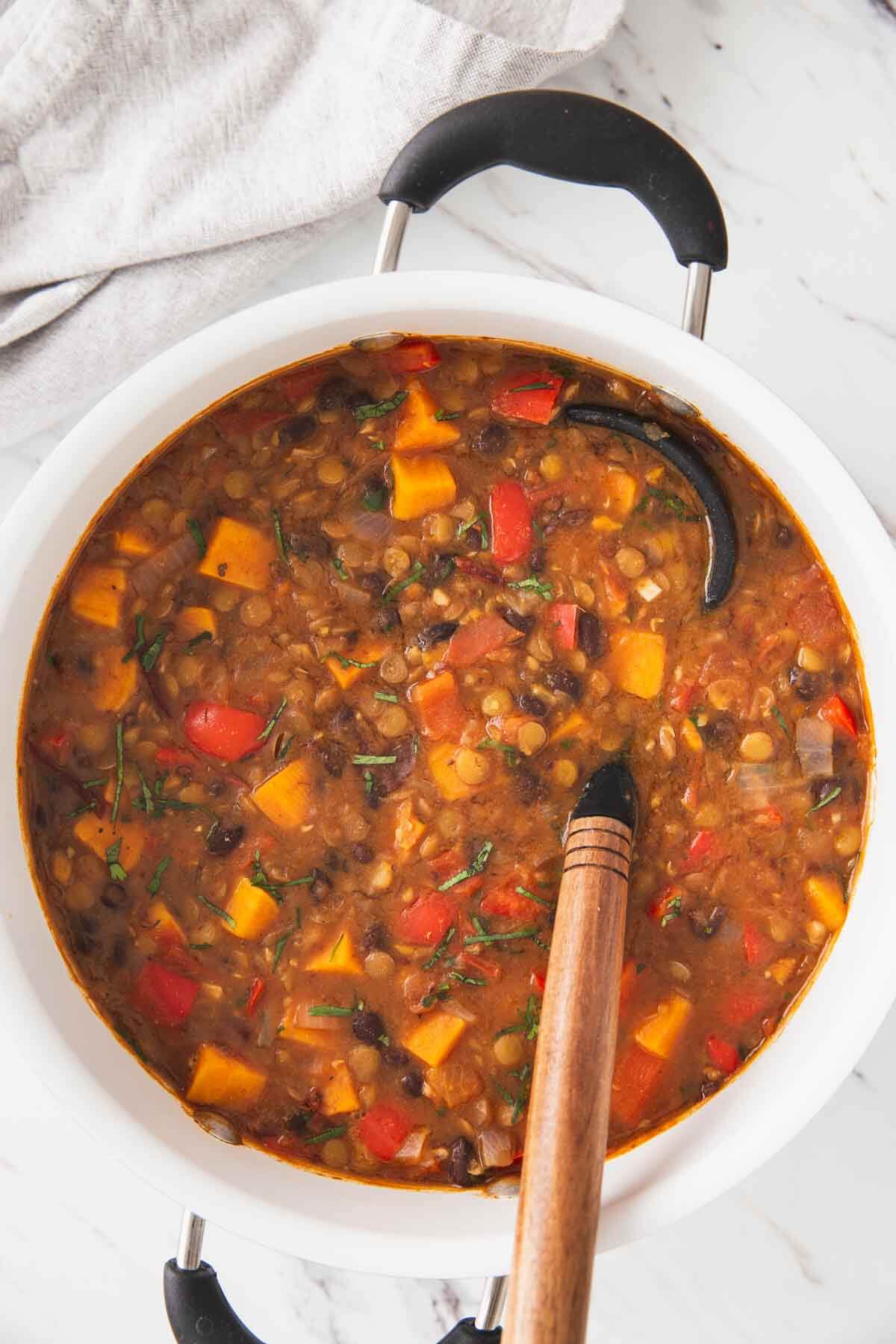 Sweet potato lentil chili prepared in a large pot and is ready to serve.