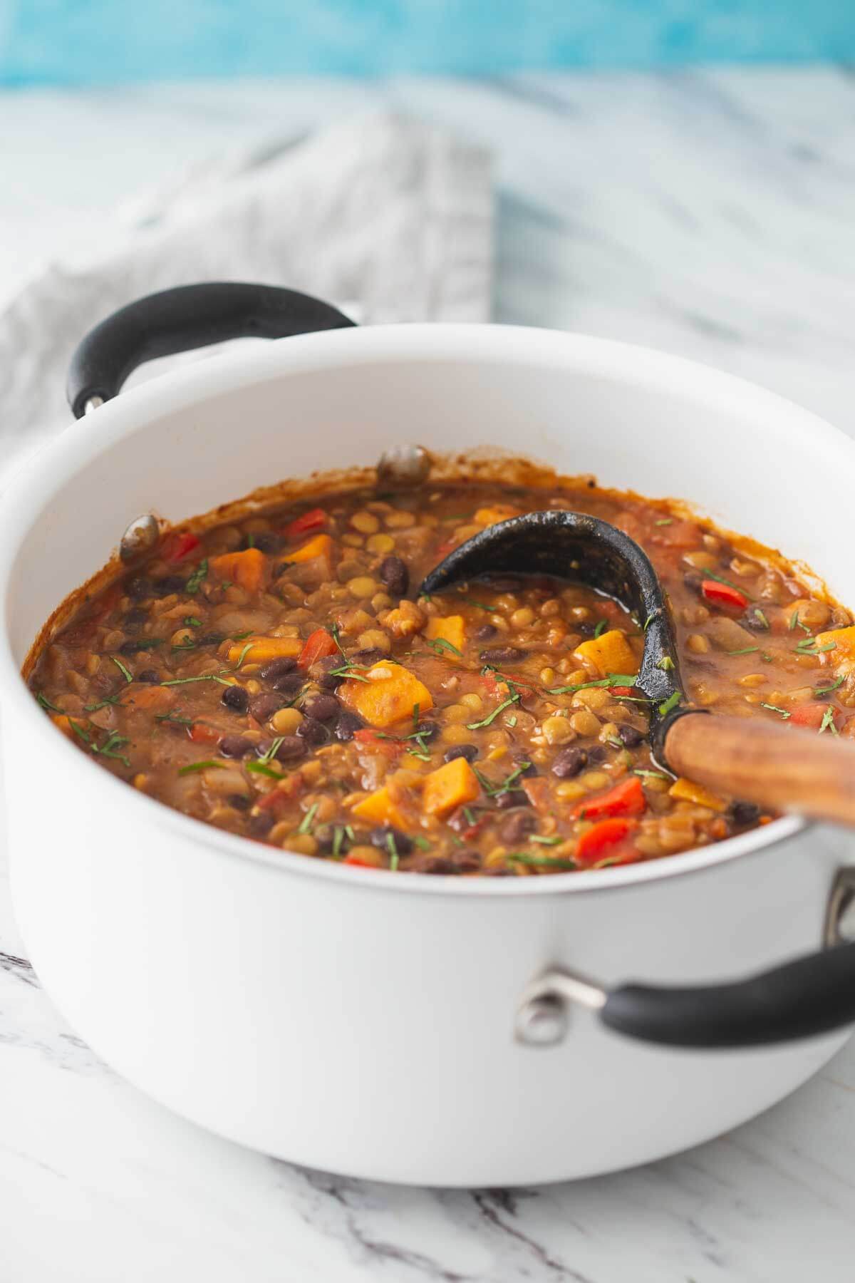 Sweet potato lentil chili prepared in a large pot and is ready to serve.