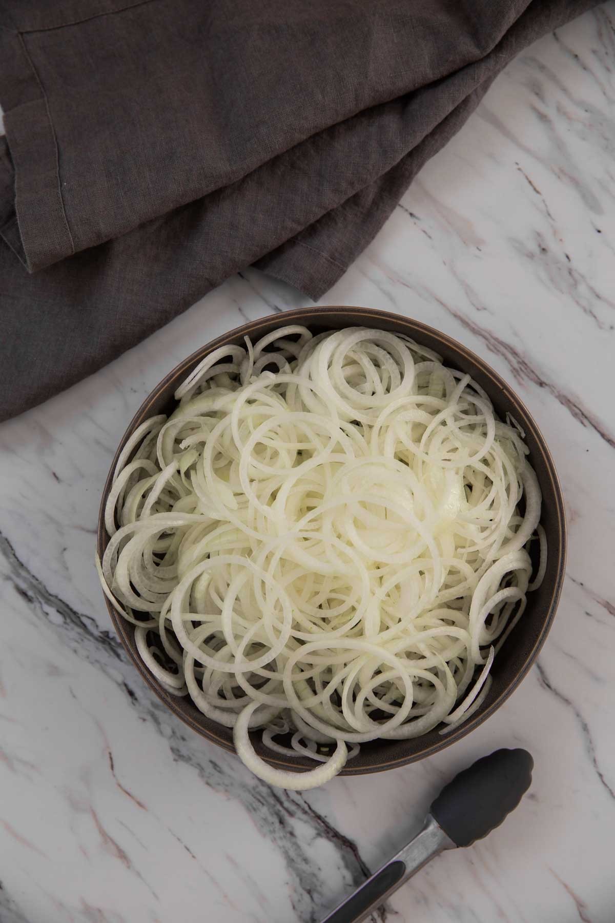 * Onion rings in a large shallow dish ready to fry in the air fryer.