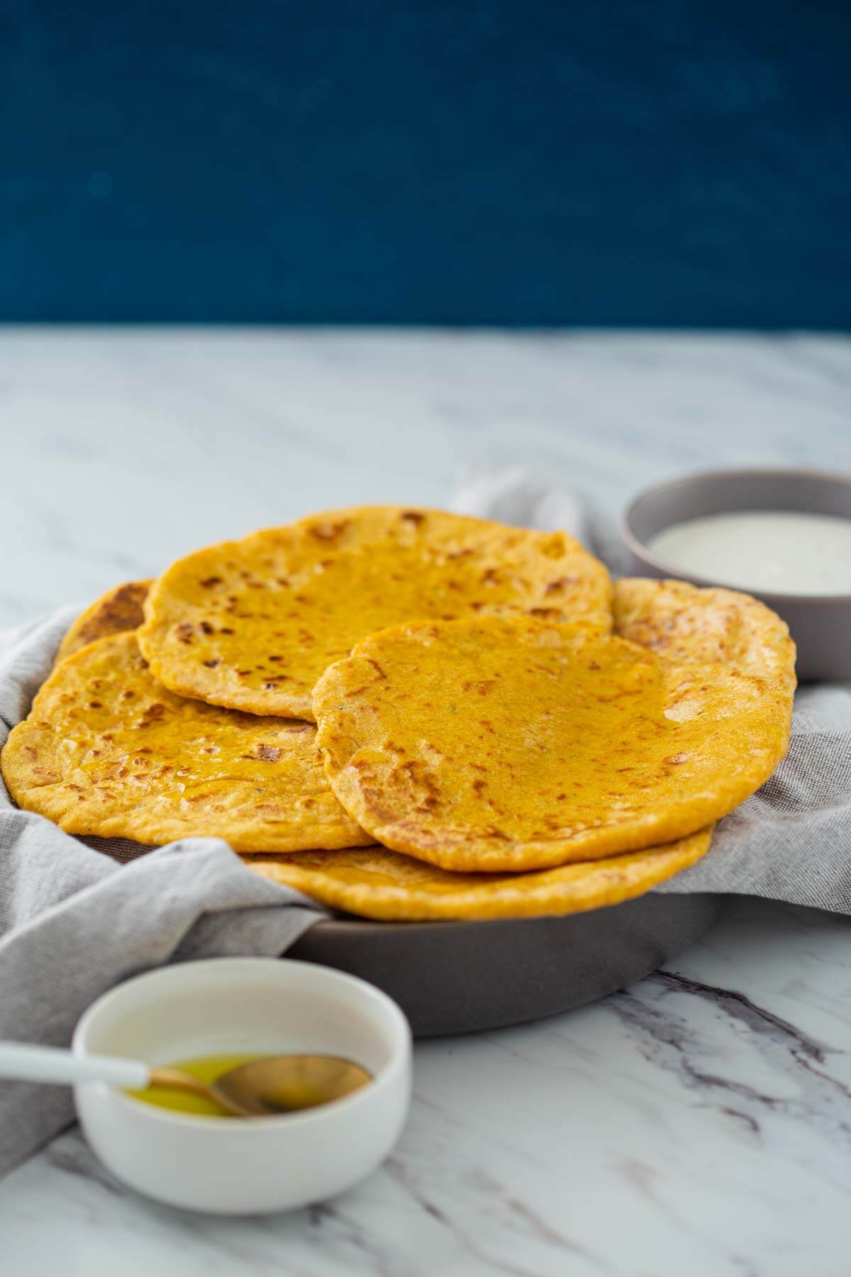 Pumpkin flatbreads in a serving dish are read to serve.