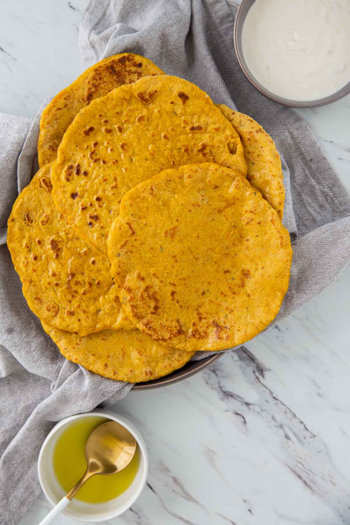 Pumpkin flatbreads in a serving dish are read to serve.