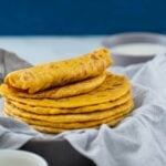 Pumpkin flatbreads stacked in a serving dish are read to serve.