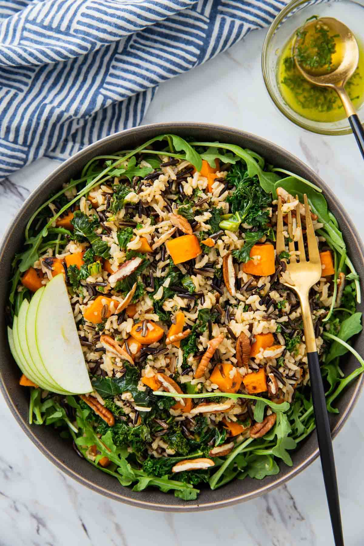 Sweet potato wild rice salad in a serving bowl with serving fork.