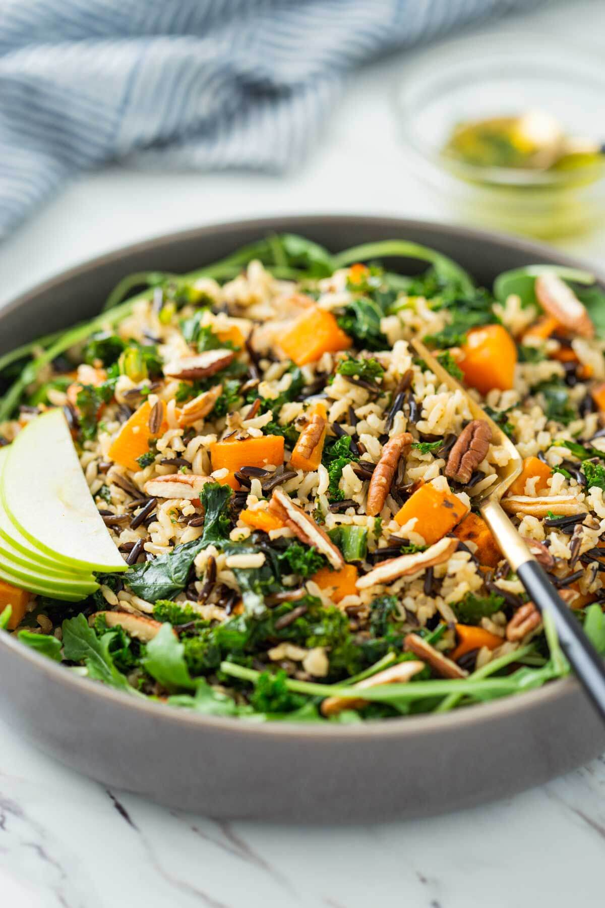 Sweet potato wild rice salad in a serving bowl with serving fork.