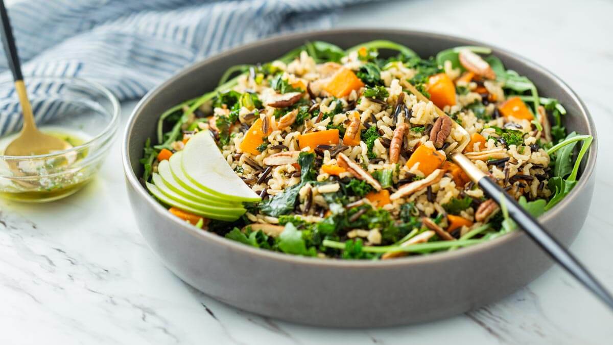 Sweet potato wild rice salad in a serving bowl with serving fork.