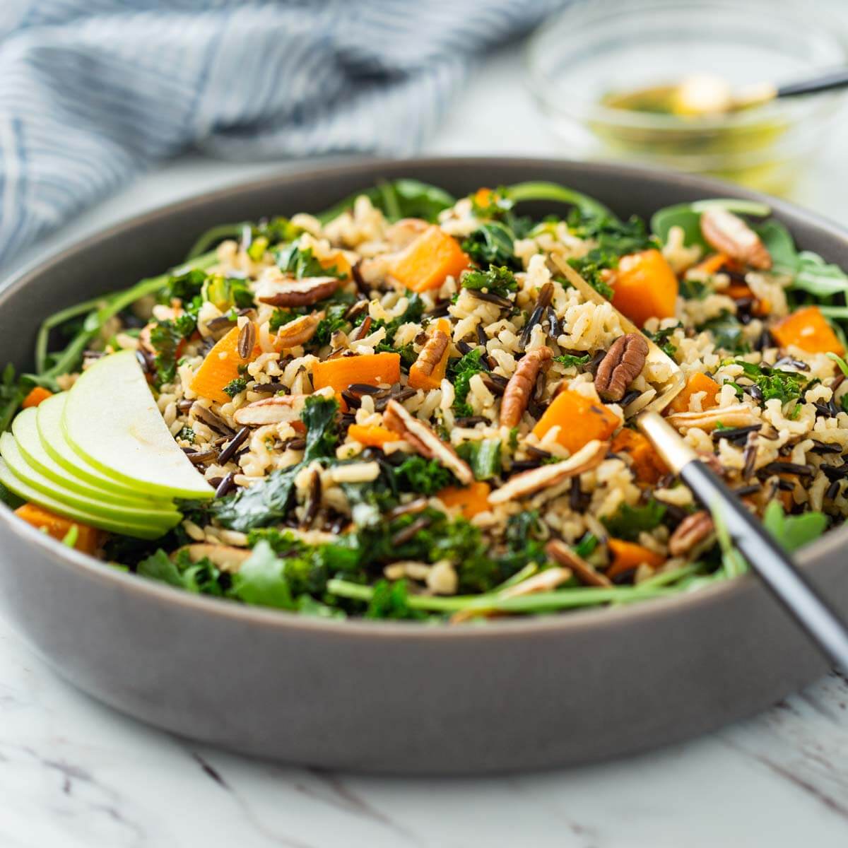 Sweet potato wild rice salad in a serving bowl with serving fork.