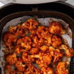 image of cauliflower wings with bbq sauce in an air fryer basket. It also has text overlay that reads 'Air fryer bbq cauliflower wings'