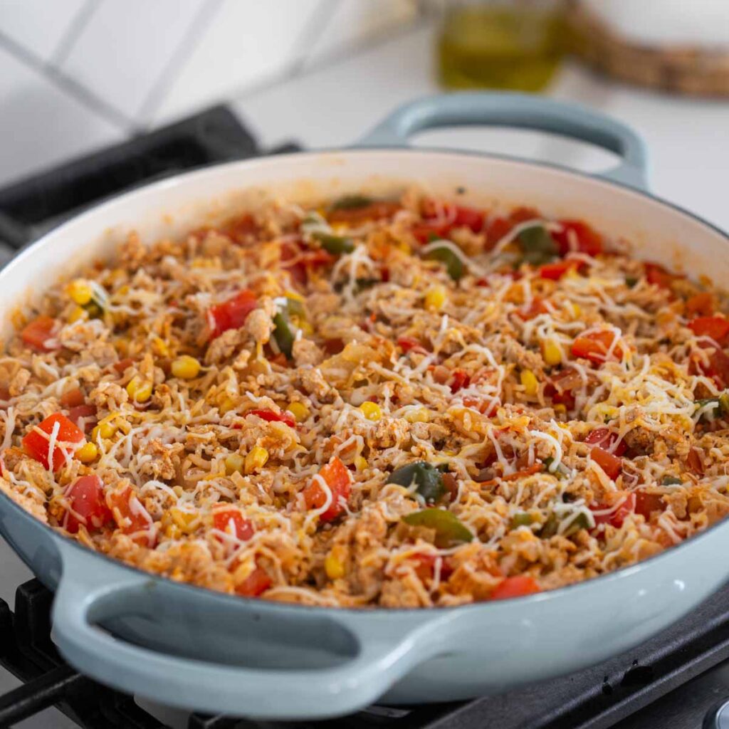 chicken taco rice with cheese in a large skillet