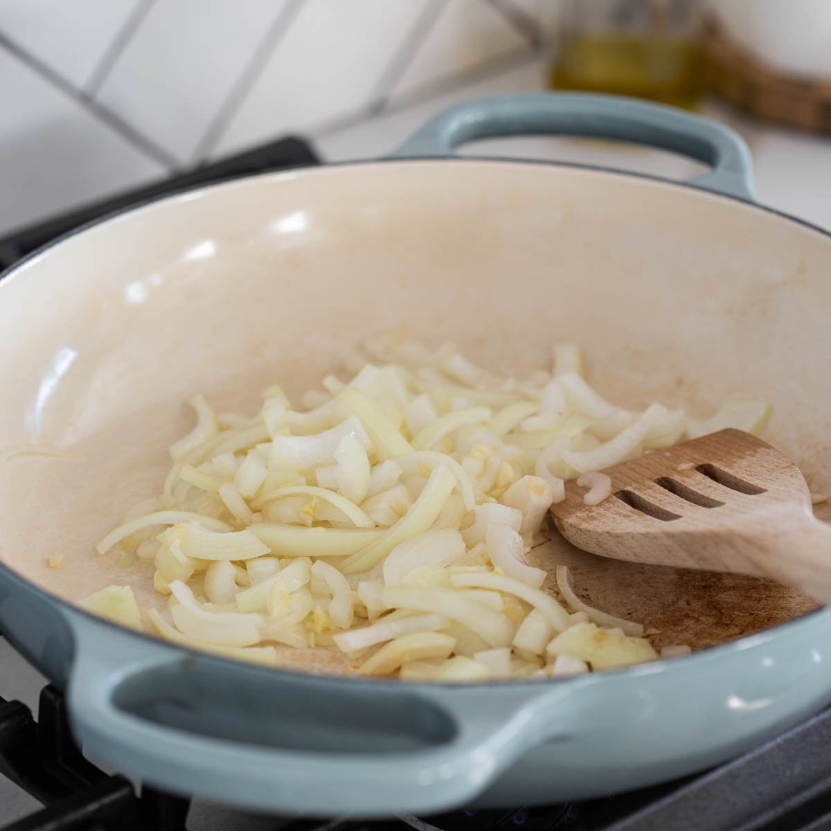 cooking onion with garlic in a skillet