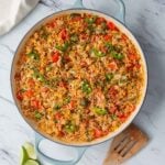 taco rice casserole with ground chicken is prepared in a large cast iron skillet.