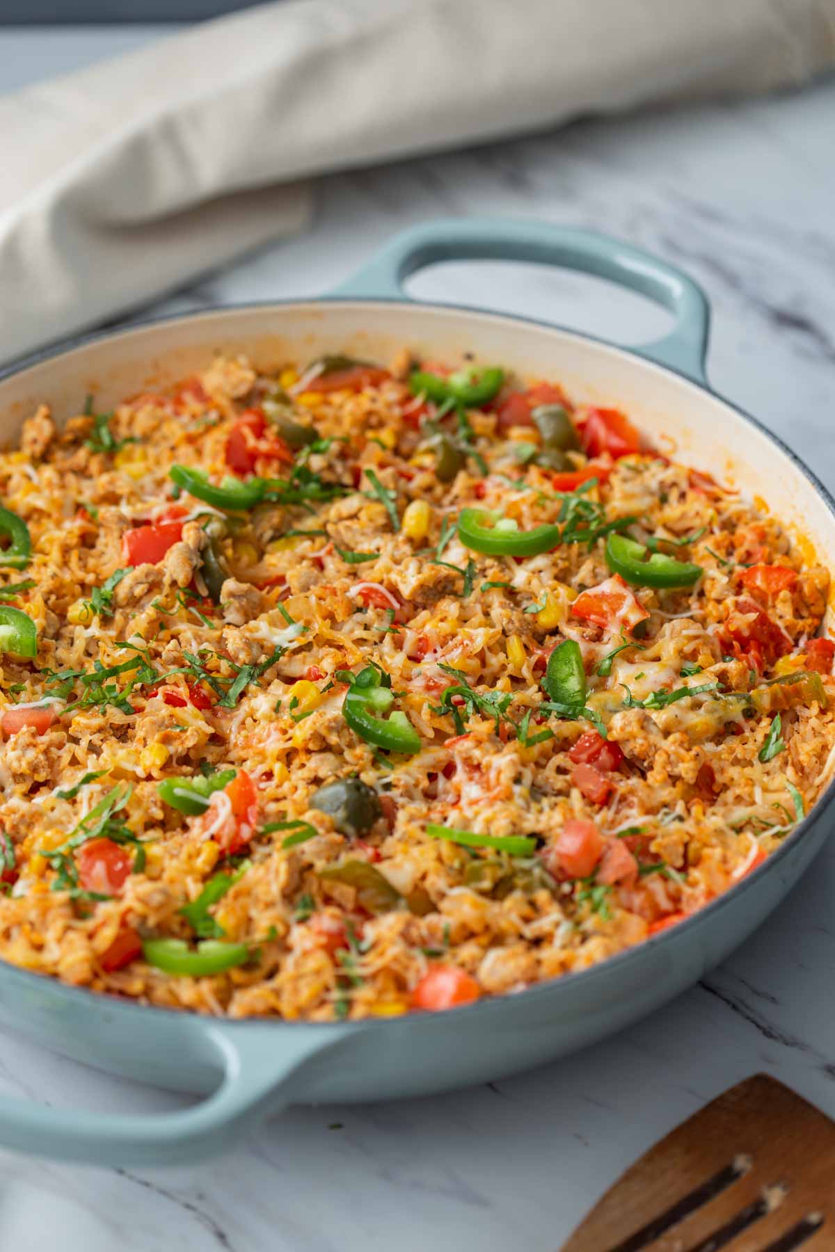 Chicken taco rice casserole prepared in a large cast iron skillet.