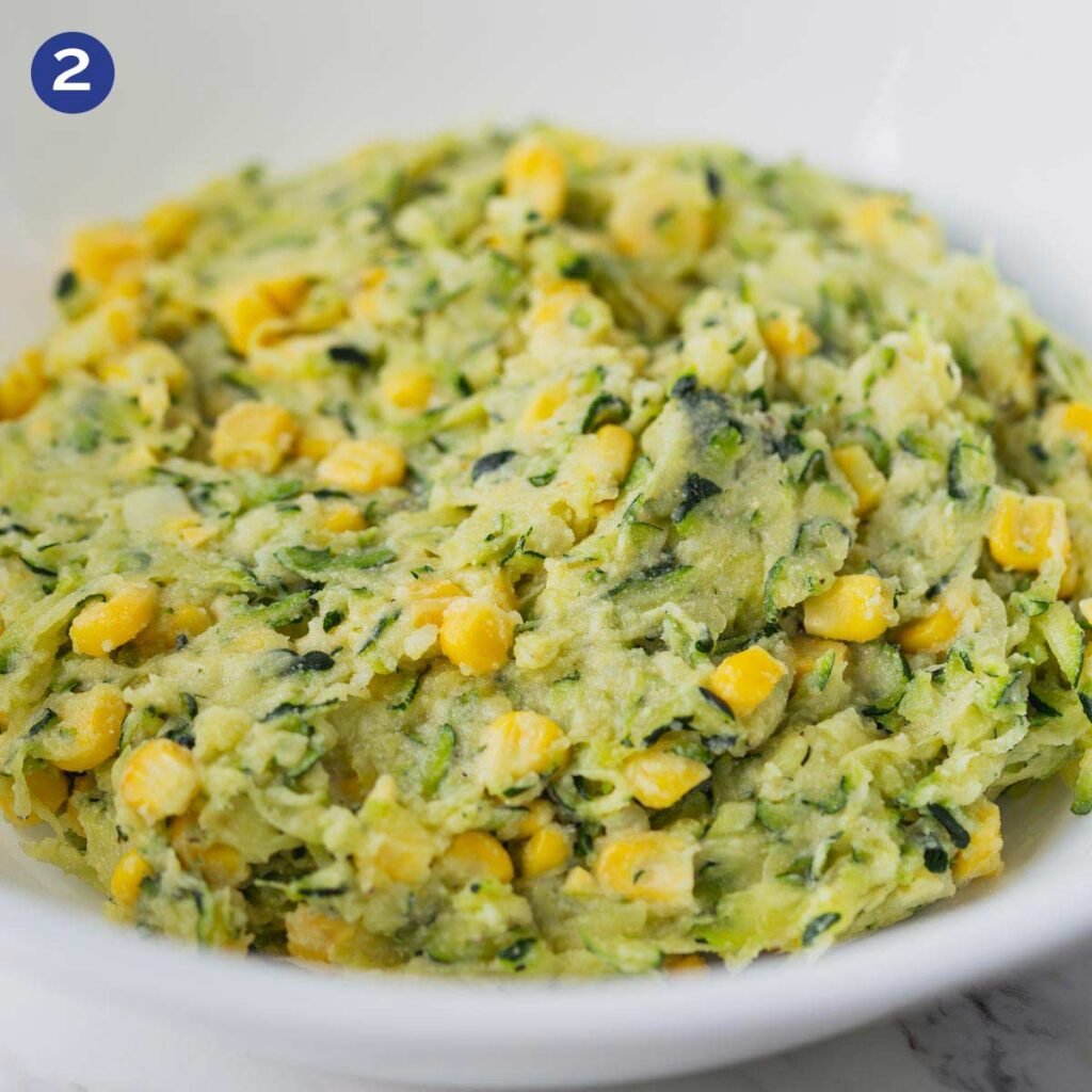 Zucchini corn batter in a bowl for making zucchini fritters.