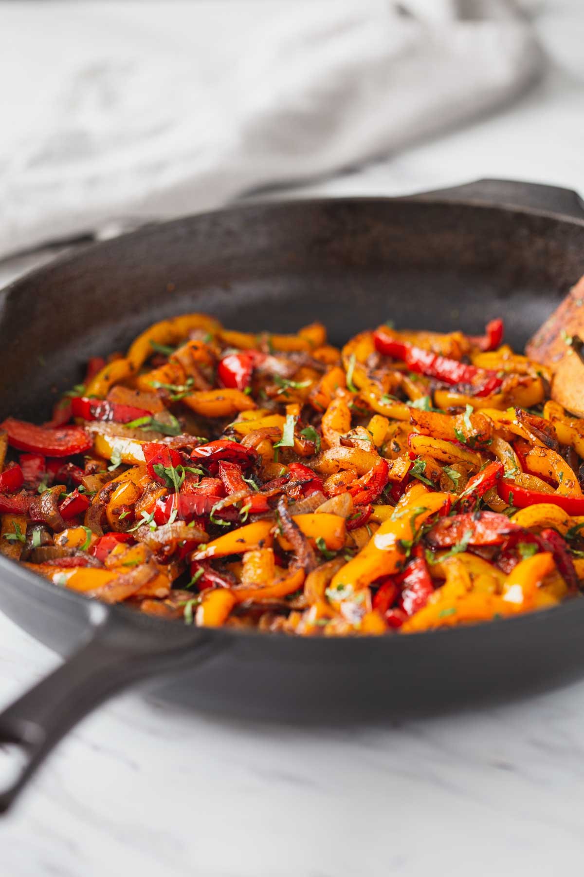 Roasted peppers and onion in a cast iron pan.