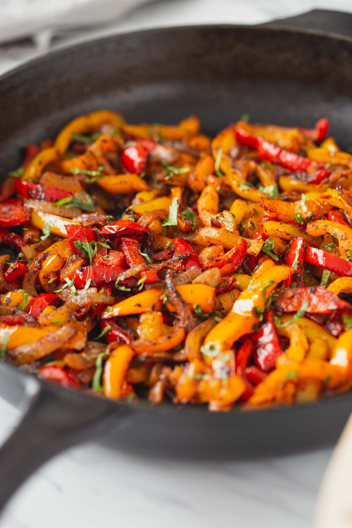 Roasted fajita veggies in a cast iron pan.