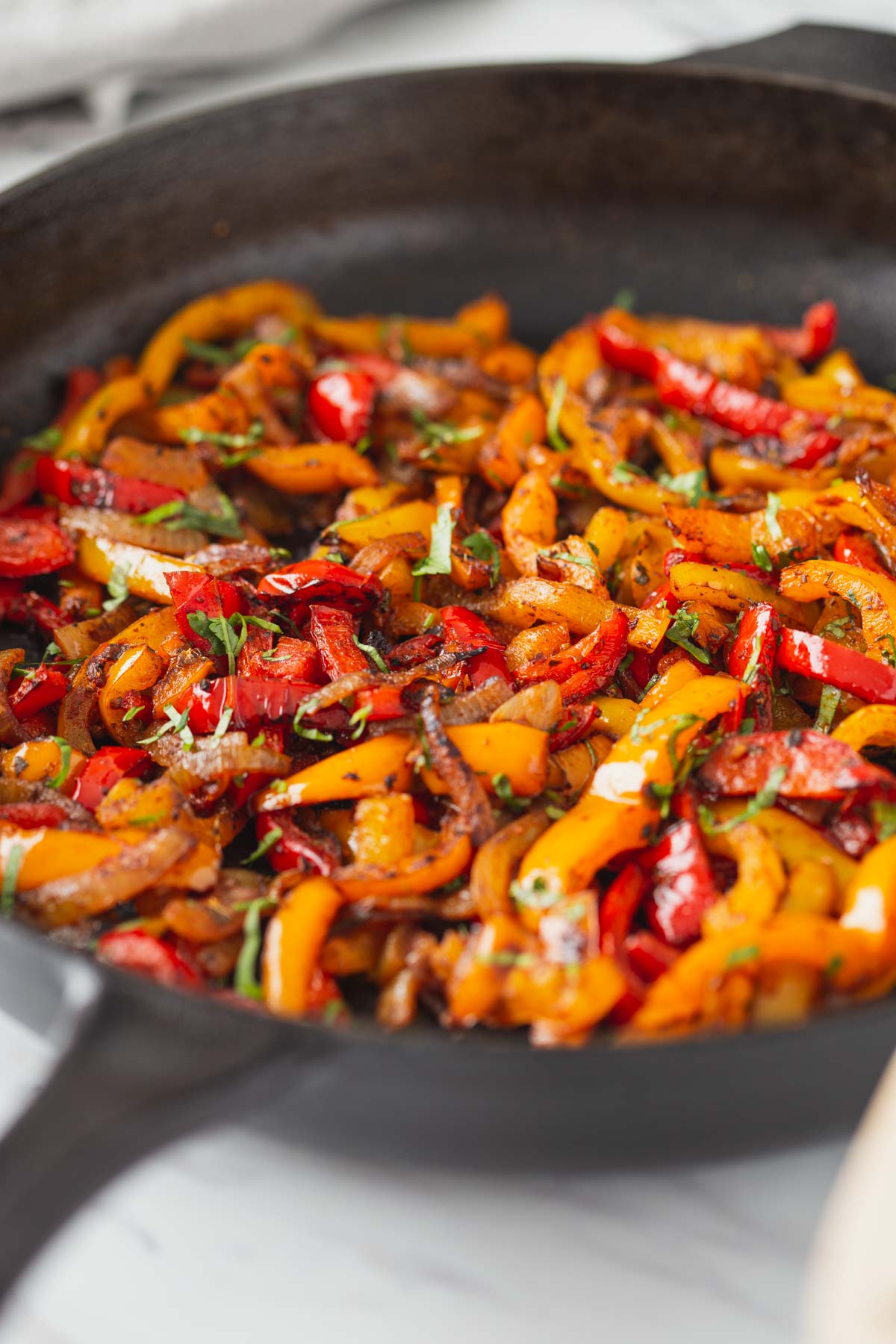 Roasted fajita veggies in a cast iron pan.