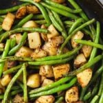 Green beans and potatoes in a skillet pin image with text overlay.