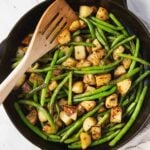 Green beans and potatoes in a skillet pin image with text overlay.