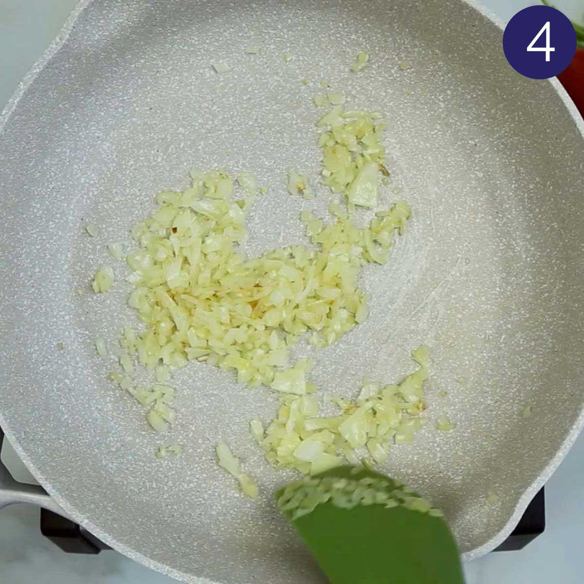 Sautéd onion in a large skillet for making shrimp curry.