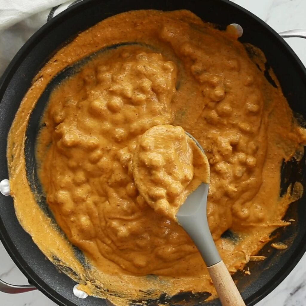 Chickpea tikka masala in a skillet with a serving spoon. 
