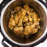 Chicken drumsticks in Instant Pot coated with lemon garlic sauce and garnished with fresh parsley. It is a pin image with text overlay.