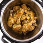 Chicken drumsticks in Instant Pot coated with lemon garlic sauce and garnished with fresh parsley. It is a pin image with text overlay.