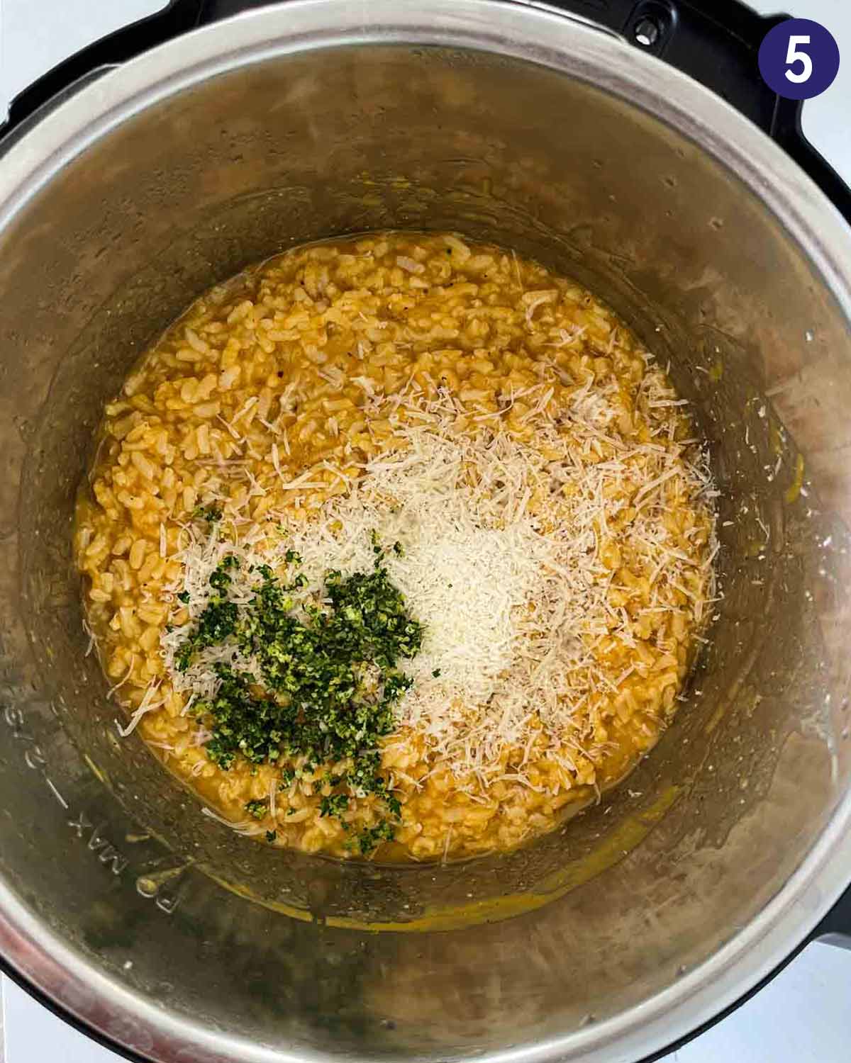 Pumpkin risotto after cooking in Instant Pot with fresh gremolata and parmesan cheese.