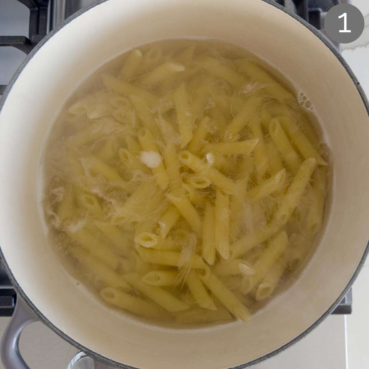 Pasta while cooking in a pot.